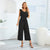 Schwarzer jumpsuit mit gürtel - elegante midi-romper für frauen