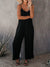 Elegante schwarze damen-jumpsuit mit weitem bein und spaghetti-träger